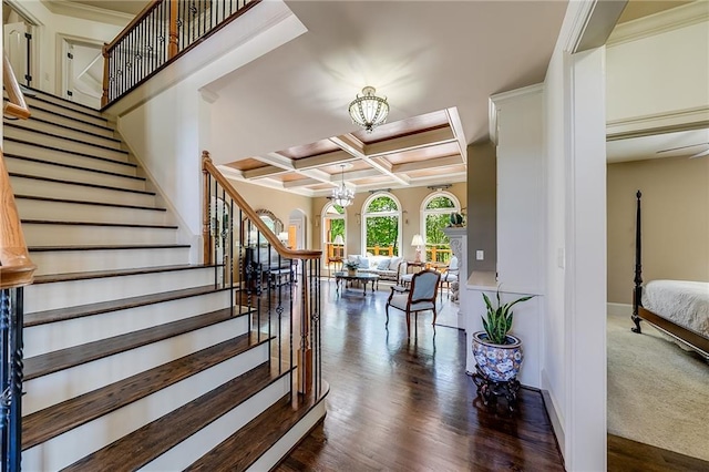 5925 Boulder Bluff Dr, Cumming, GA 30040 - living room featuring dark wood-style flooring, beamed ceiling, a chandelier, coffered ceiling, and a premium fireplace