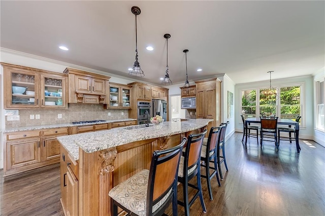 5925 Boulder Bluff Dr, Cumming, GA 30040 - kitchen featuring appliances with stainless steel finishes, a sink, arched walkways, a large island with sink, and dark wood-style floors