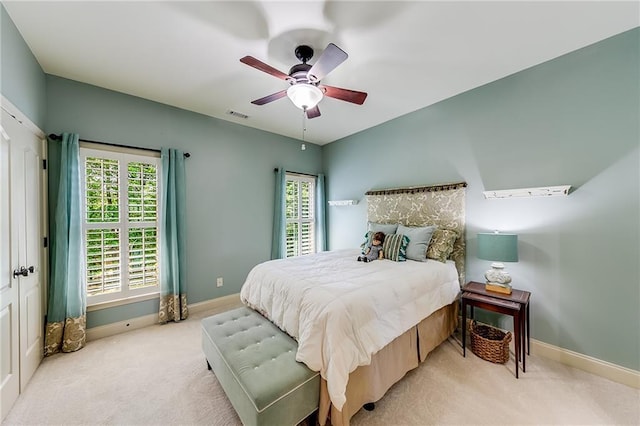 5925 Boulder Bluff Dr, Cumming, GA 30040 - bedroom with visible vents, multiple closets, ceiling fan, light colored carpet, and connected bathroom