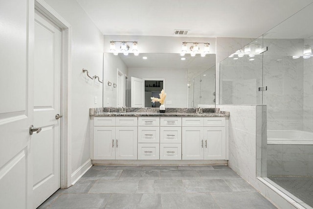 bathroom with double vanity and a stall shower