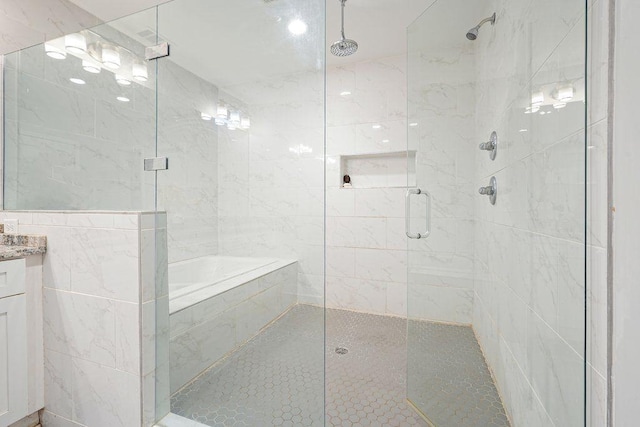 bathroom featuring a shower stall and vanity