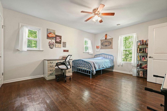 bedroom featuring wood finished floors, baseboards, and a ceiling fan