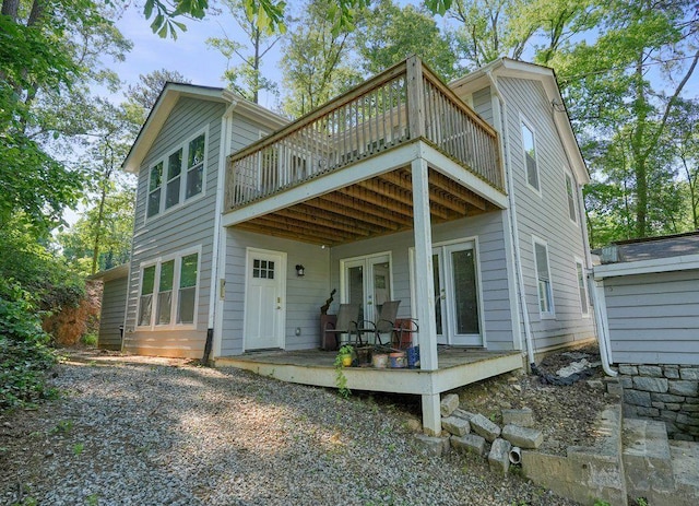 rear view of house with french doors and a deck