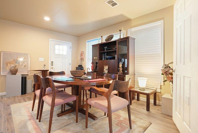 dining space featuring light wood finished floors, baseboards, and recessed lighting