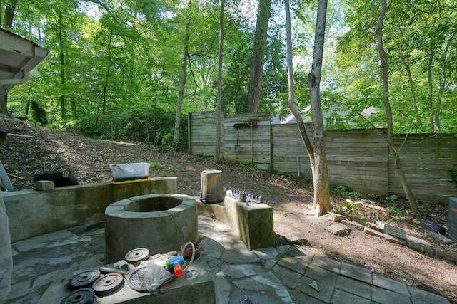 fenced backyard featuring a fire pit and a patio area