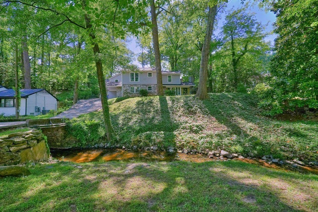 view of green lawn with a garage