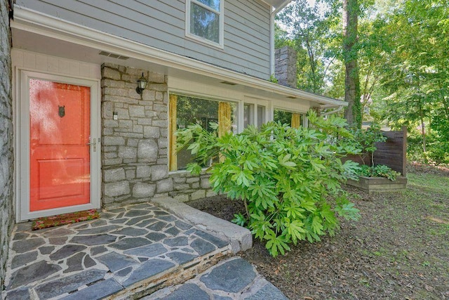 entrance to property with stone siding