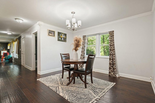dining space with baseboards, a chandelier, hardwood / wood-style floors, and ornamental molding