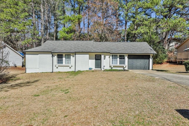 ranch-style house with an attached garage, driveway, and a front yard