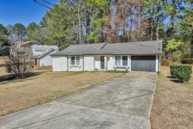 single story home with an attached garage, concrete driveway, a front yard, and roof with shingles