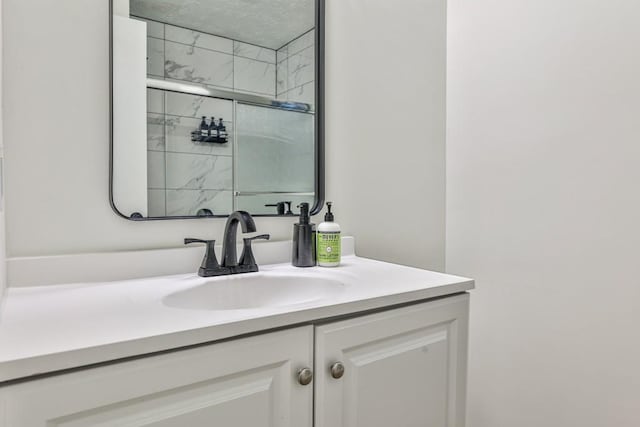 bathroom with an enclosed shower and vanity