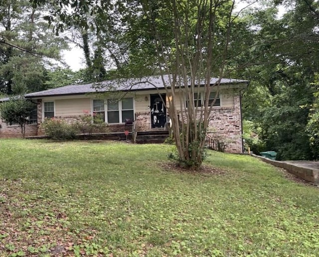 single story home with a front lawn and brick siding