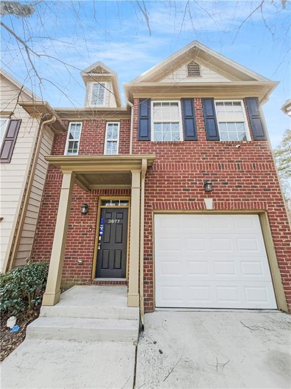 view of front of home featuring concrete driveway, an attached garage, and brick siding