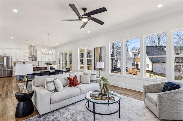 living area with dark wood-style floors, plenty of natural light, and crown molding