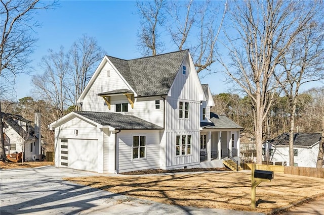 modern farmhouse style home featuring driveway, a garage, a shingled roof, covered porch, and board and batten siding