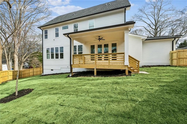 back of house featuring crawl space, fence, a deck, and a lawn