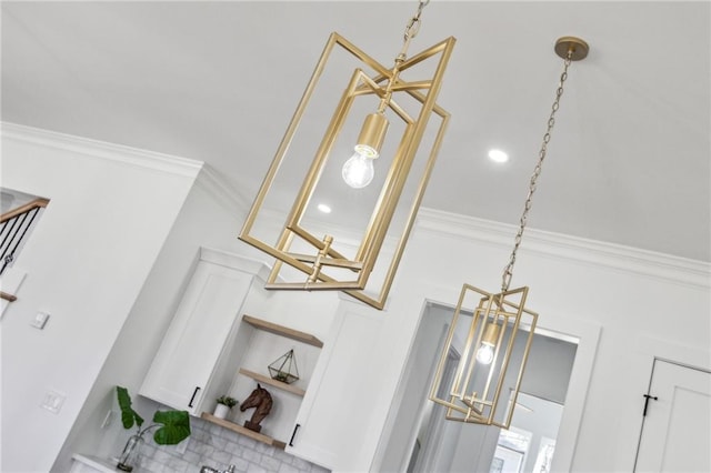 interior details with white cabinetry, crown molding, and open shelves