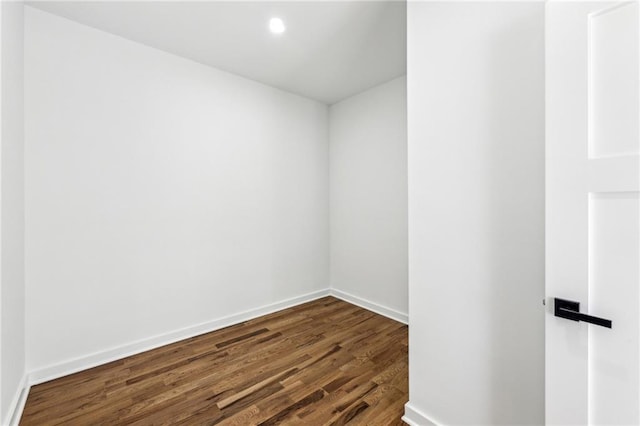 unfurnished room with dark wood-style floors, recessed lighting, and baseboards