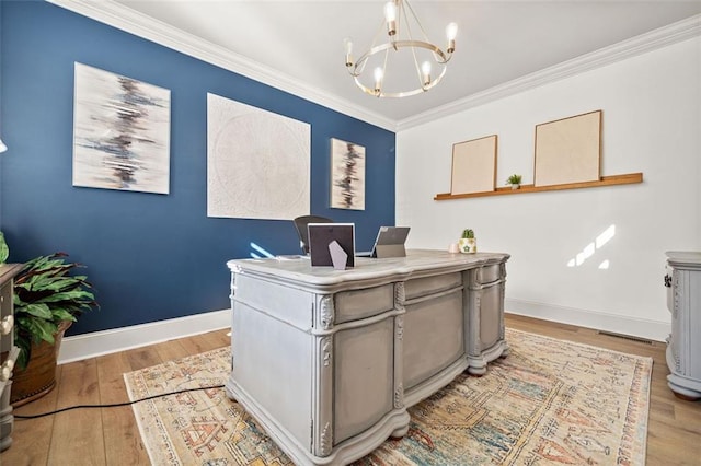 office space featuring an inviting chandelier, ornamental molding, and light hardwood / wood-style flooring