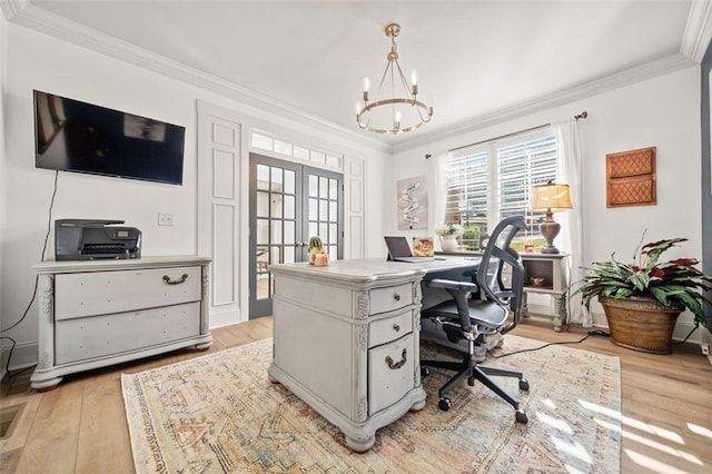 office area with light hardwood / wood-style floors, ornamental molding, french doors, and an inviting chandelier