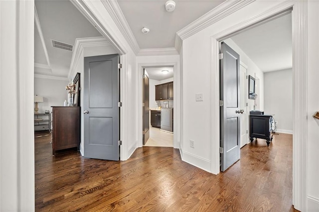 hallway featuring hardwood / wood-style floors and ornamental molding