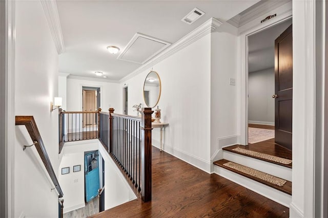 stairs with wood-type flooring and crown molding