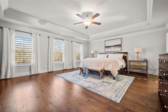 bedroom featuring a raised ceiling and multiple windows