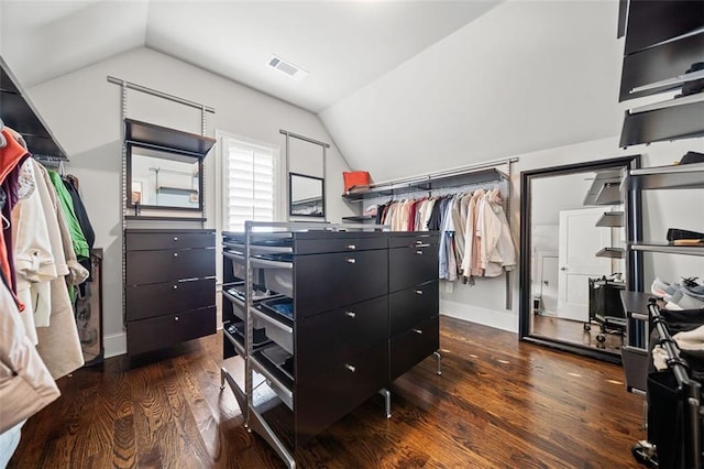 walk in closet featuring dark hardwood / wood-style floors and vaulted ceiling