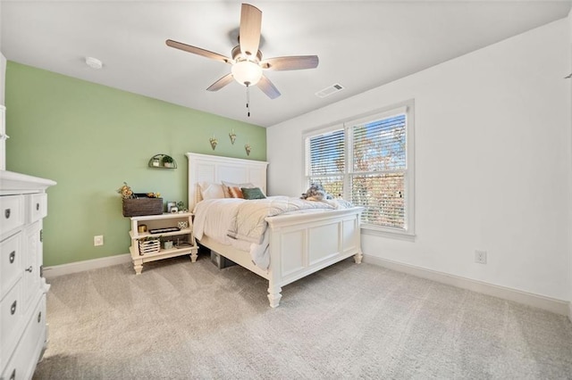 bedroom featuring ceiling fan and light carpet