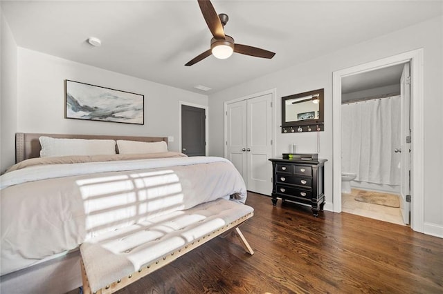 bedroom featuring ensuite bathroom, ceiling fan, dark hardwood / wood-style flooring, and a closet