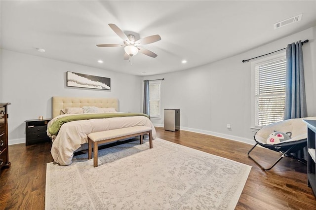 bedroom featuring ceiling fan and dark hardwood / wood-style floors