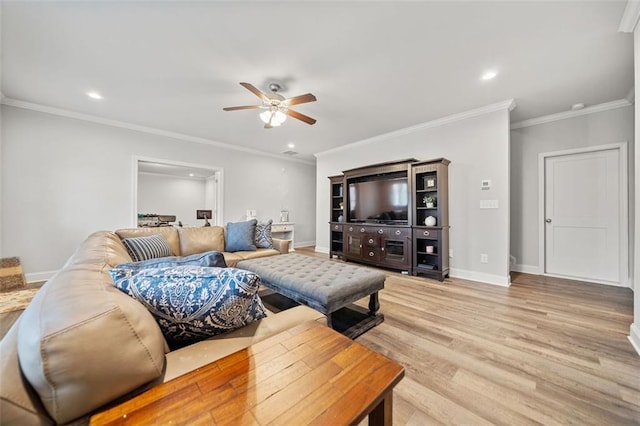 living room with light hardwood / wood-style floors, ceiling fan, and crown molding