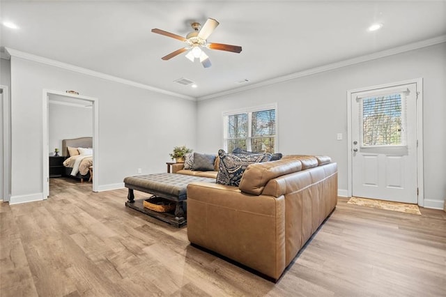 living room featuring light wood-type flooring, ceiling fan, and crown molding