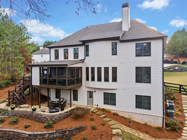 back of house with a patio, a sunroom, and central air condition unit