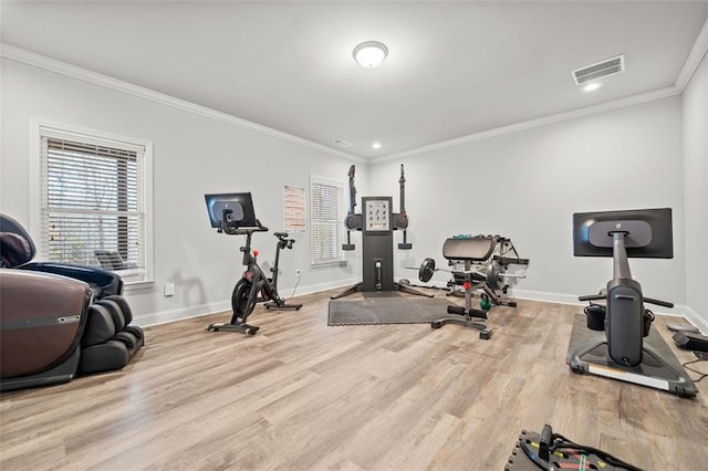 exercise area with light hardwood / wood-style flooring and crown molding