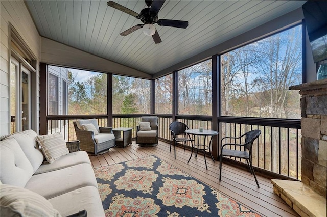 sunroom with ceiling fan, wooden ceiling, and vaulted ceiling