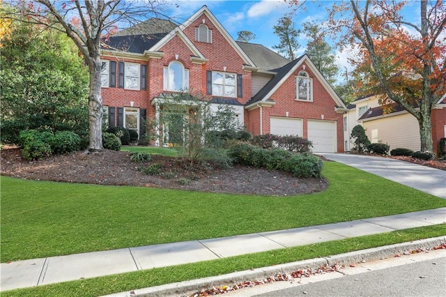 view of front of house featuring a garage and a front lawn