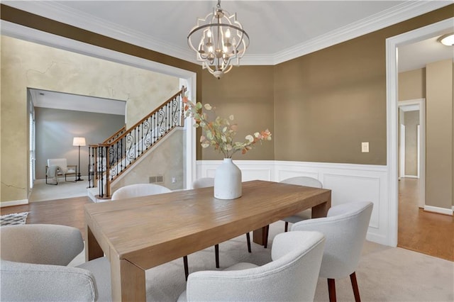 dining area featuring ornamental molding and a notable chandelier