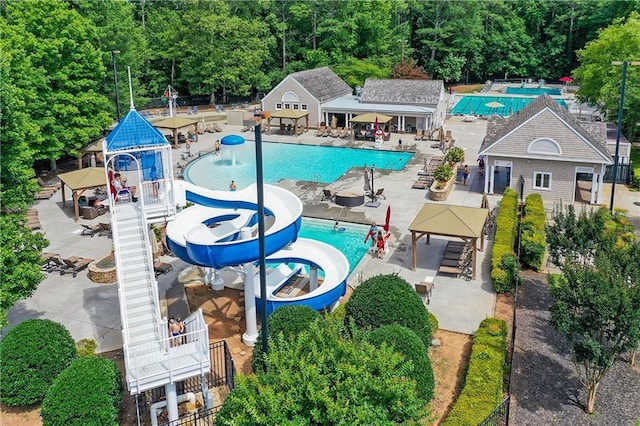 view of swimming pool with a patio and a water slide