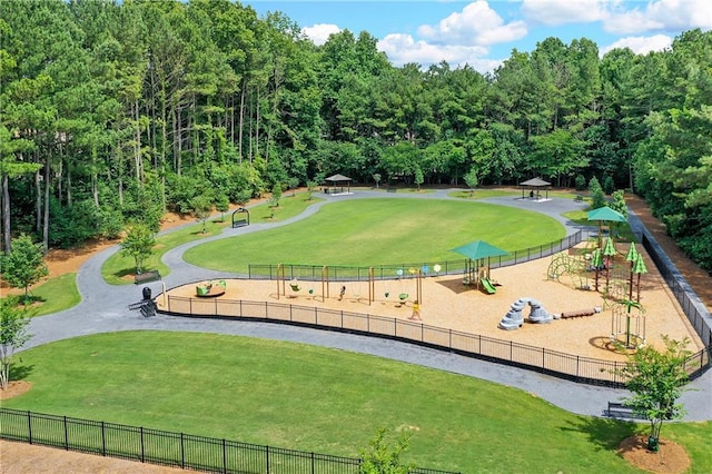 surrounding community featuring a playground and a lawn