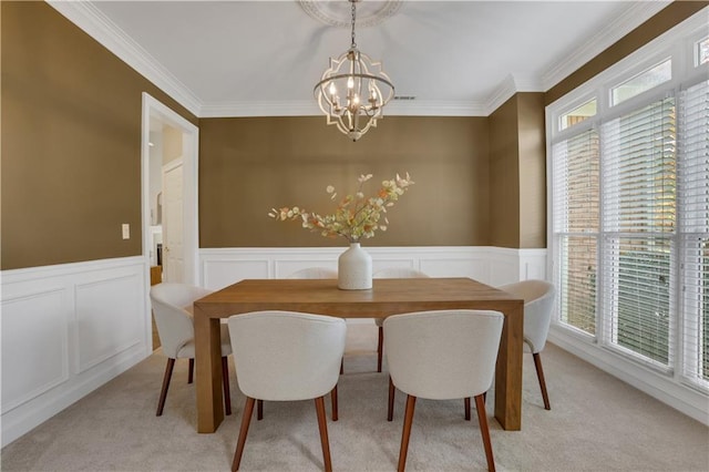 dining room featuring light carpet, crown molding, and an inviting chandelier