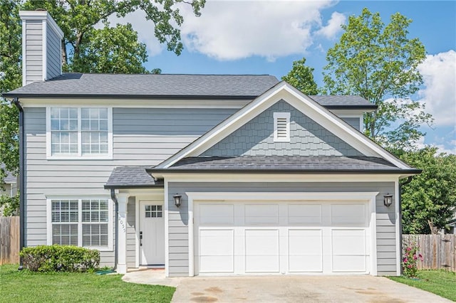 view of front of property with concrete driveway, a chimney, an attached garage, and a shingled roof