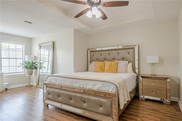 bedroom featuring dark wood-style floors, baseboards, a textured ceiling, and ceiling fan