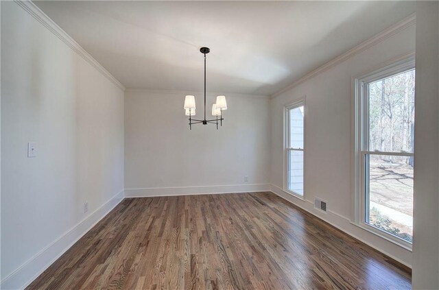 unfurnished dining area featuring baseboards, visible vents, dark wood finished floors, and ornamental molding