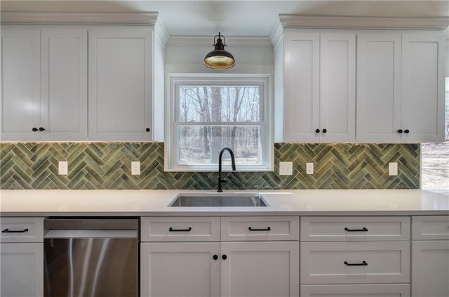 kitchen featuring dishwasher, light countertops, and a sink