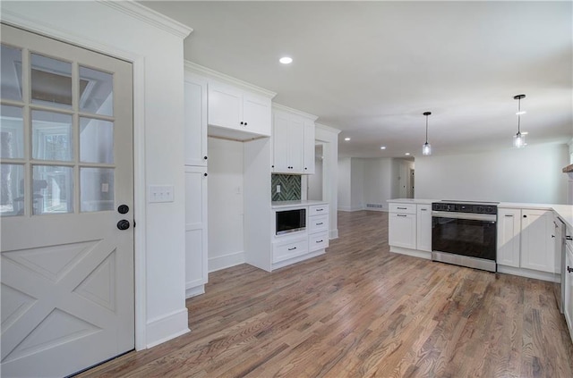 kitchen with electric stove, light wood-type flooring, white cabinetry, and built in microwave