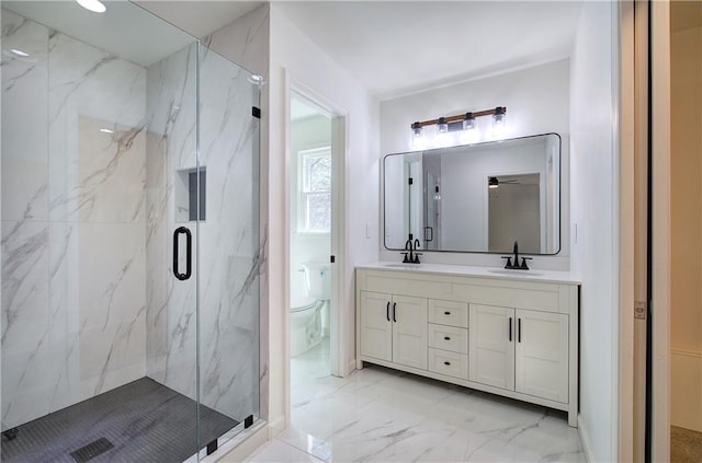 full bath featuring marble finish floor, a sink, a marble finish shower, and toilet