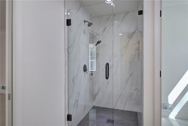 bathroom with a marble finish shower