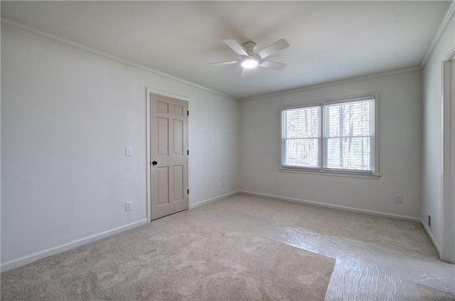 unfurnished room featuring ornamental molding, light colored carpet, and baseboards