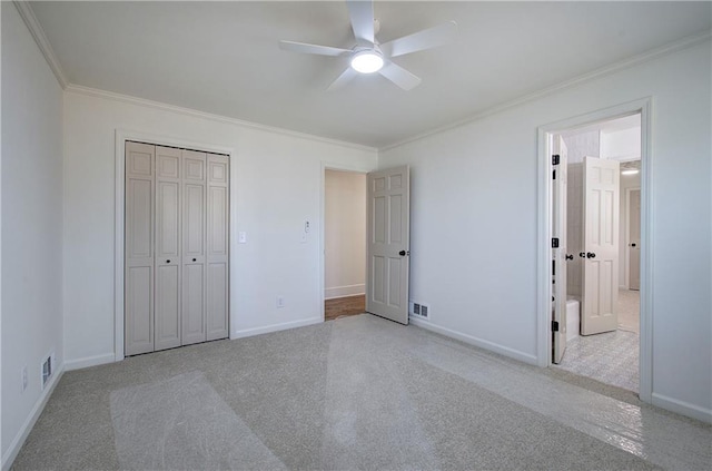 unfurnished bedroom with carpet flooring, crown molding, and visible vents